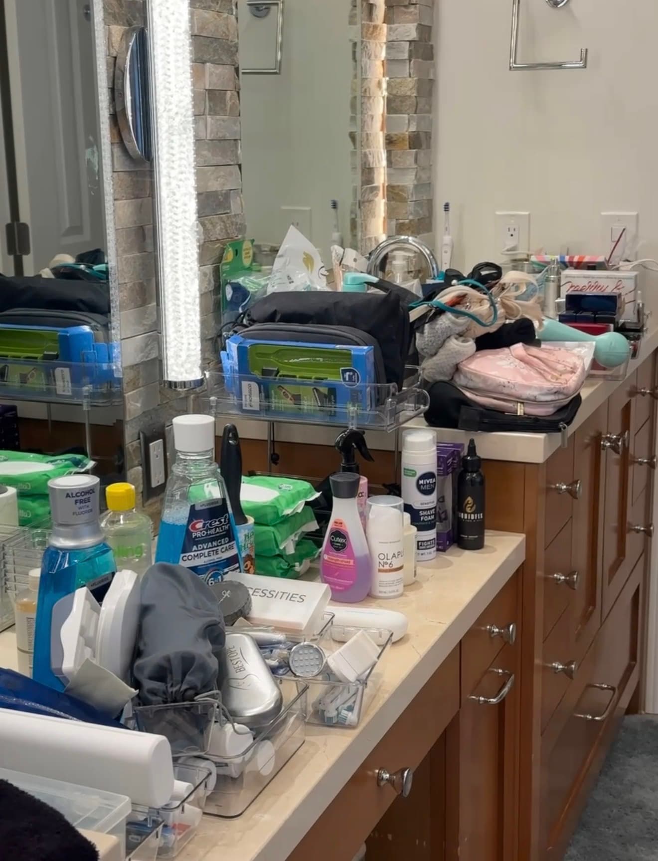Before: a bathroom vanity crowded with bags, toiletries, and containers