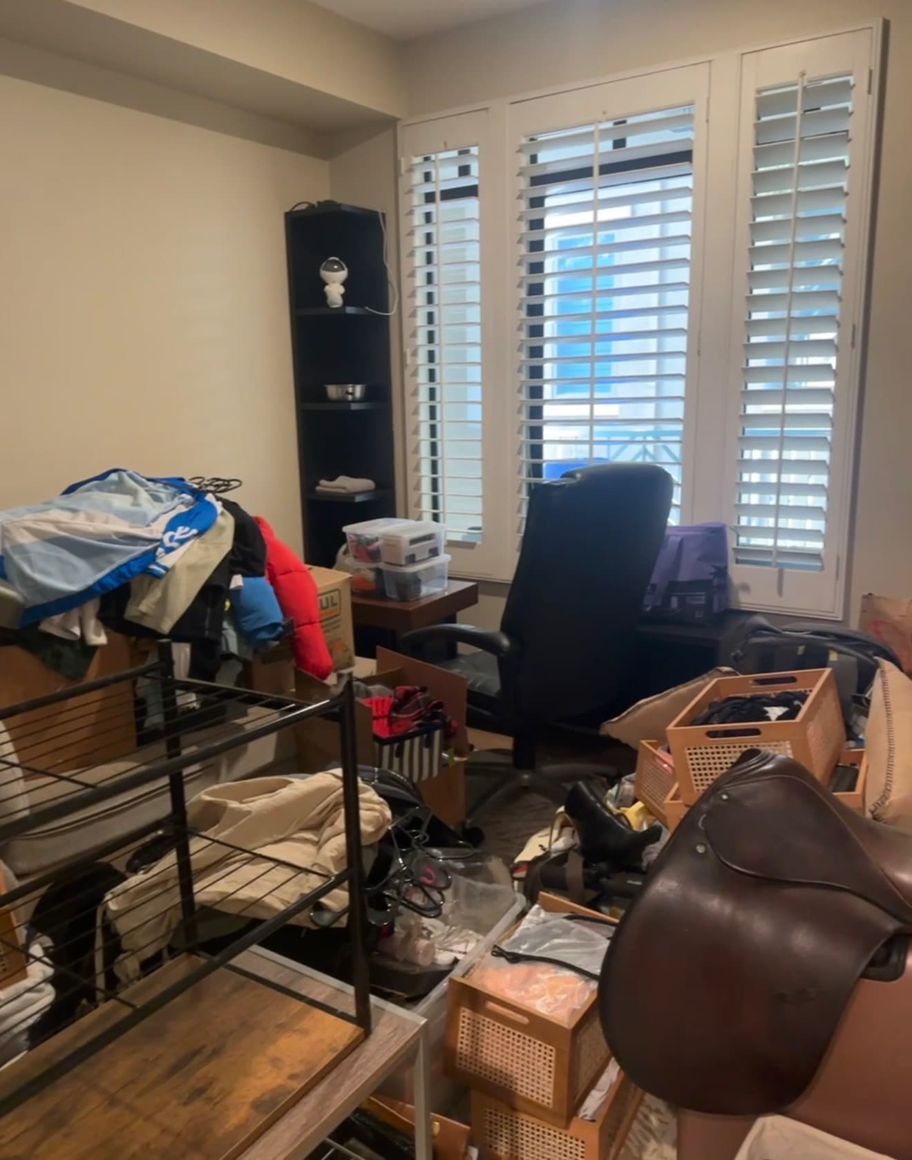 Before: a home office filled with boxes, clothing, and furniture